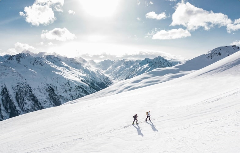 Two individuals taking a journey by hiking up a mountain